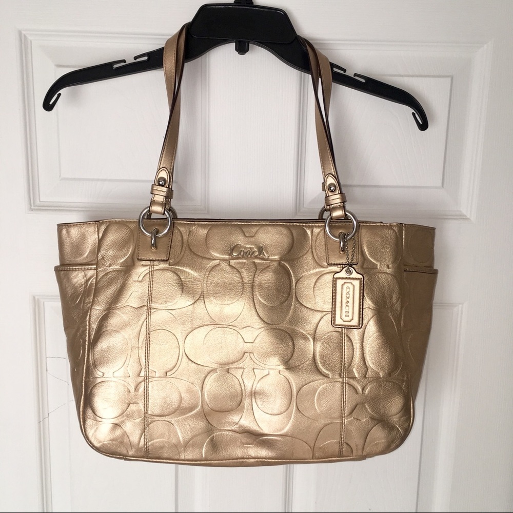 Gold coach shoulder bag.